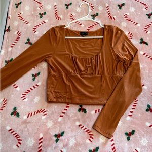 Burnt orange long sleeve crop top. Size: Medium.